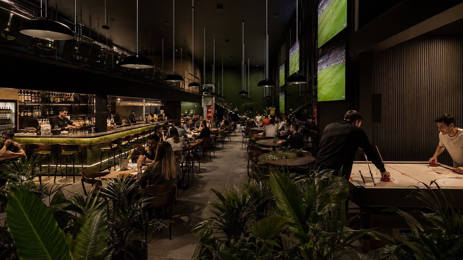 Salão do sports bar com o balcão, as telas de futebol, mesas ocupadas e a mesa de air hockey